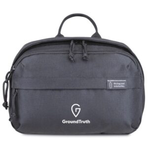 This toiletry bag is made from recycled plastic bottle fabric and comes in black or navy, shown here in black with a white custom logo.