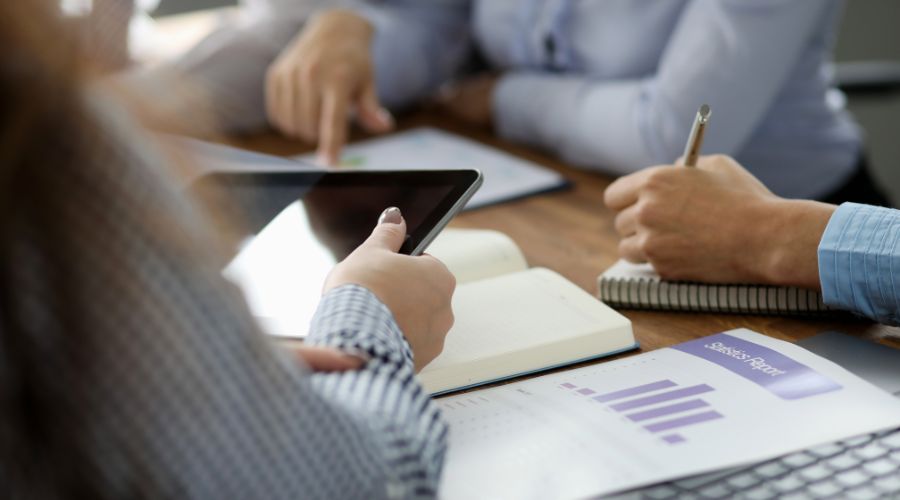 Image of people working on a sustainability consulting plan around a table