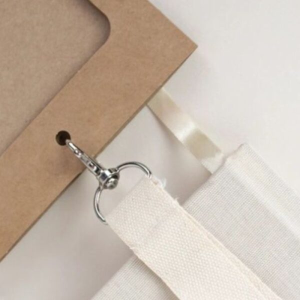 Close up of eco-friendly paper conference and event name badge with organic cotton lanyard