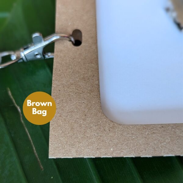 Eco-friendly, recyclable paper event badge and name tag holders in Brown Bag Grocer paper close up